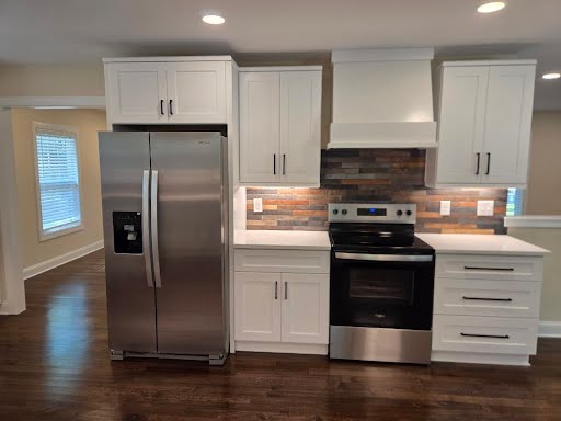 Remodeled rental kitchen with white shaker cabinets, quartz counters, and stainless appliances